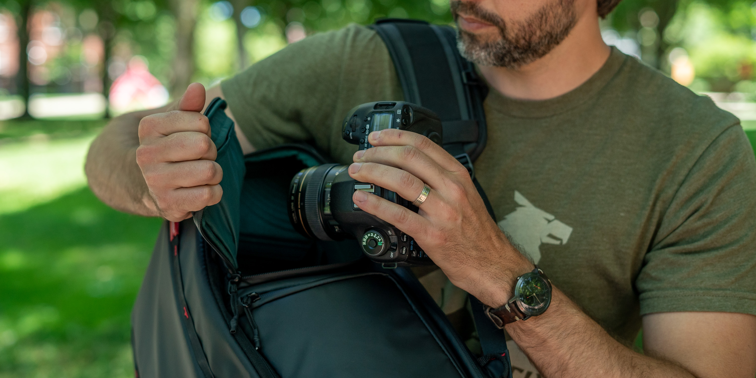 Pulling a DSLR out of the side pocket of the OneMo camera bag