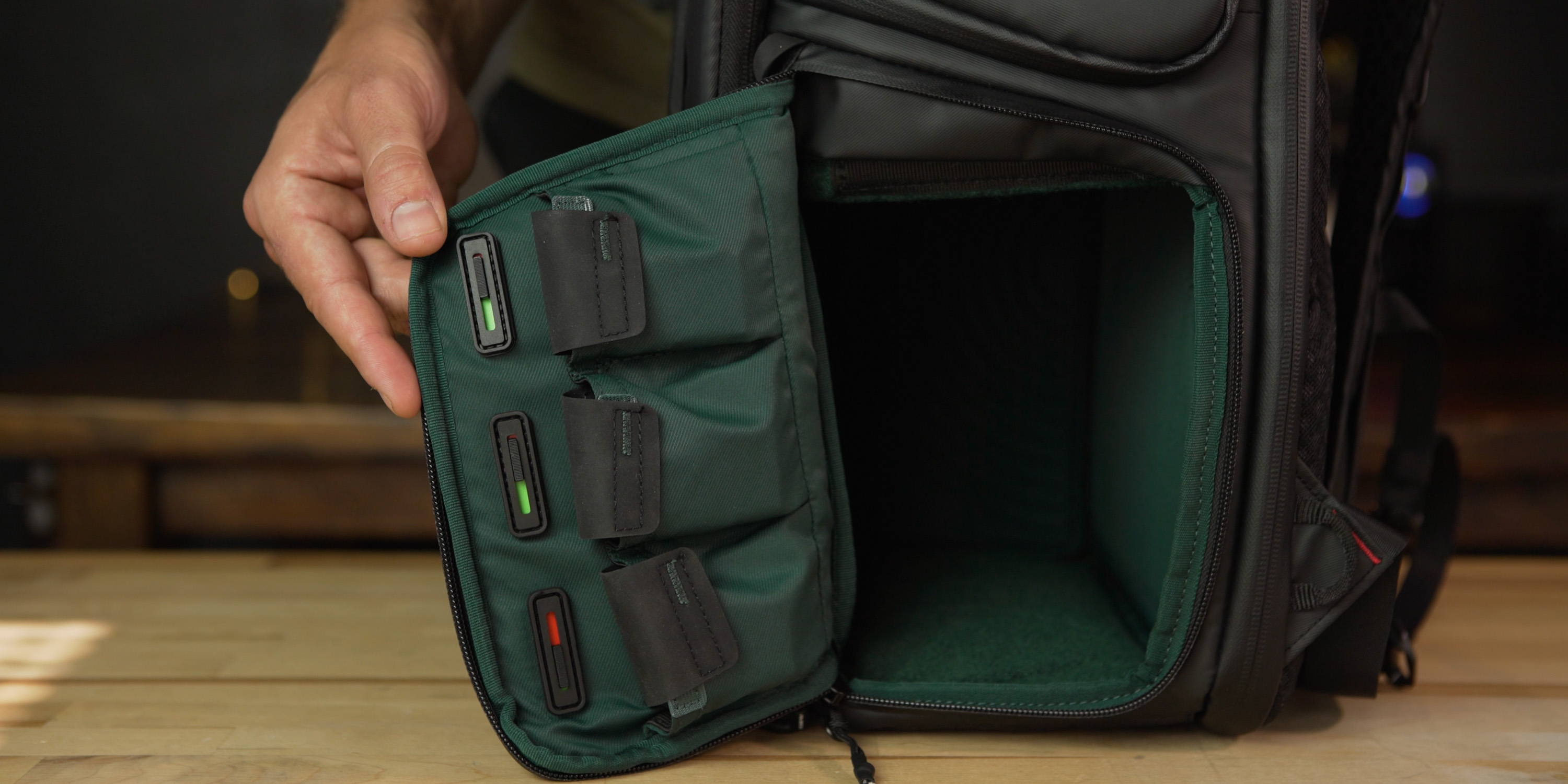 Dedicated battery pouches with charge indicators on the OneMo camera bag
